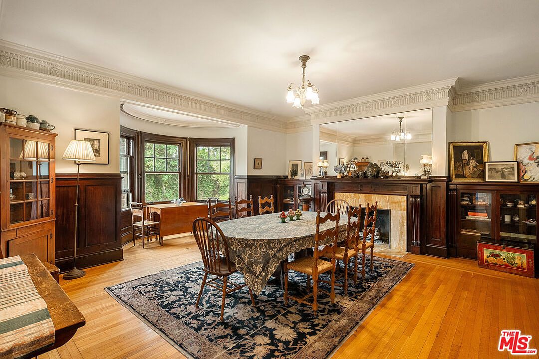 Formal dining room with paneled wainscot and a bowed bay window.